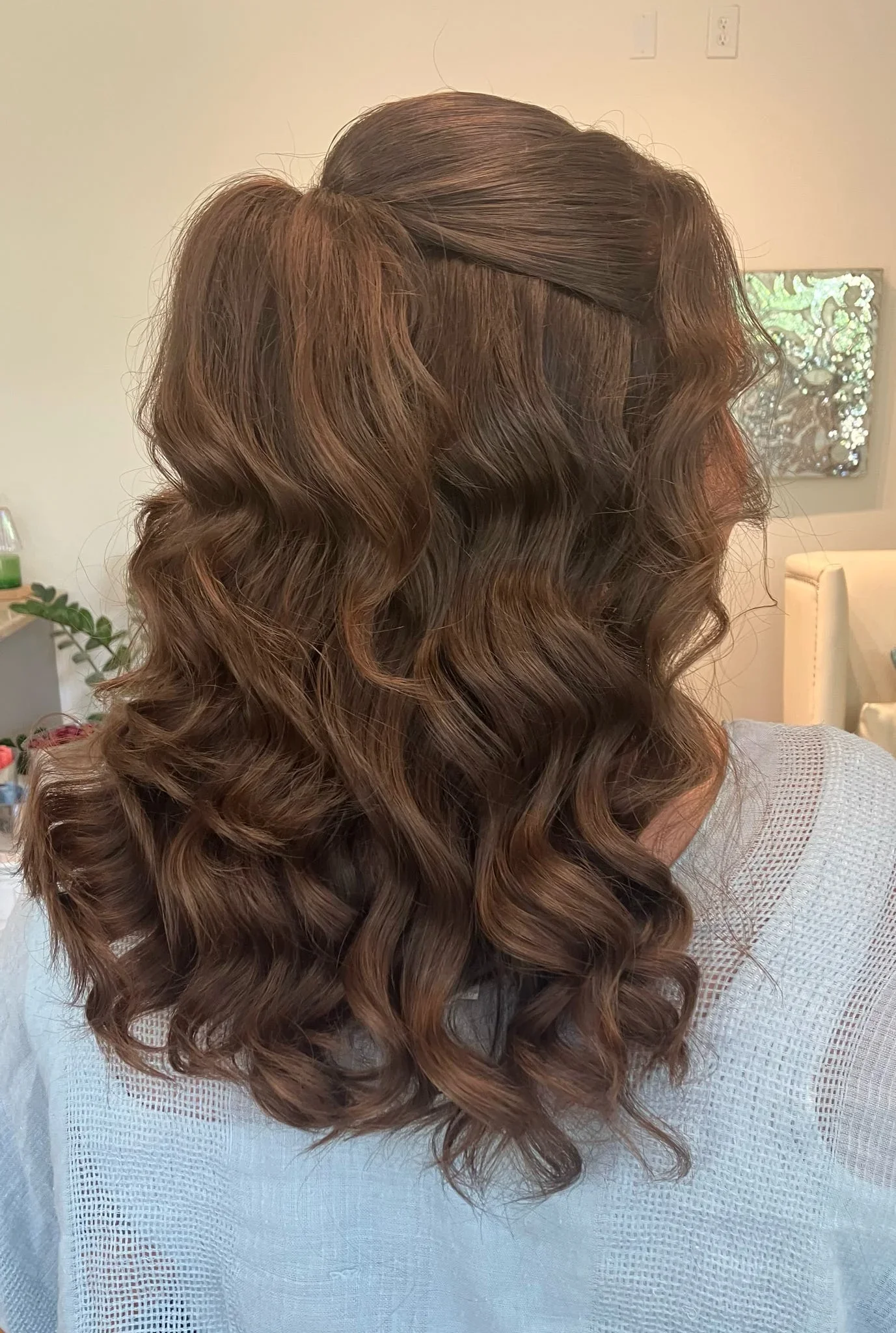 Back view of polished half-up bridal waves by Glow Salon & Spa