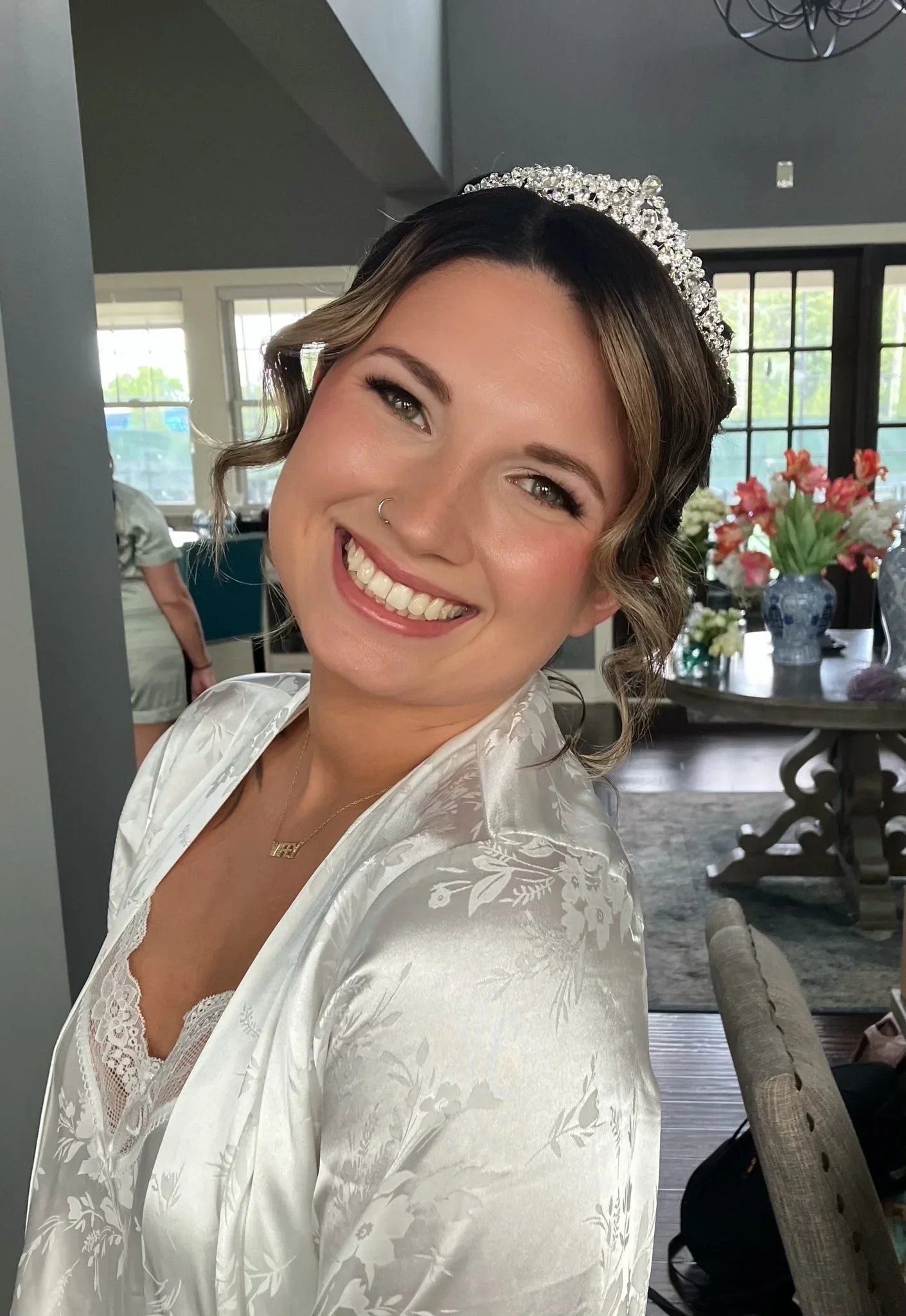 Bride with tiara, soft-glam makeup, and an elegant updo by Glow Salon & Spa